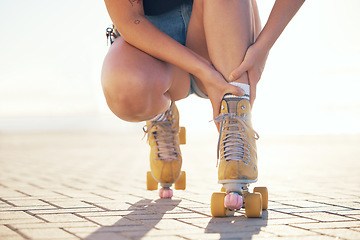 Image showing Roller skate, foot injury and woman athlete check feet and ankle sports pain in summer. Exercise, fitness and skating training muscle sprain accident of a female on a workout with a bright background