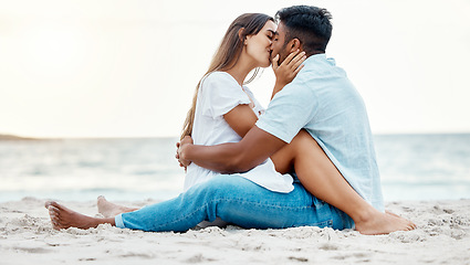 Image showing Kiss, beach and love of couple on a date for anniversary, valentines day or romance summer holiday with clear sky, ocean waves and sand. Romantic, intimate and marriage honeymoon or engagement people