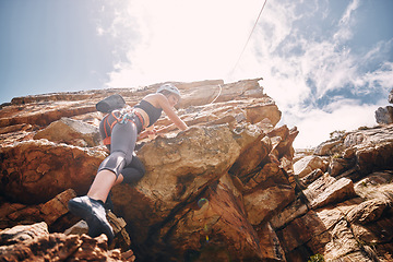 Image showing Fitness, extreme sports and rock climbing woman on a mountain, enjoy a climb in nature and freedom. Athlete, adrenaline and energy with female on adventure, physical challenge exercise cliff hanging