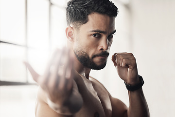 Image showing Fighter, sport and boxing portrait of man, athlete and strong boxer training, exercise and muay thai in gym or fitness club. Serious, health and fighting professional doing a workout for endurance