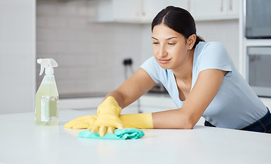 Image showing Cleaner woman cleaning kitchen counter with cloth, spray bottle and rubber gloves in modern home interior. Service worker working with soap liquid, hygiene equipment or wipe surface for spring clean