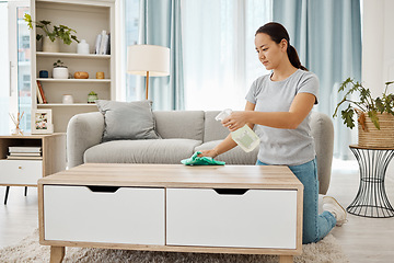 Image showing Cleaning, hygiene and house task with a woman spring cleaning, sanitize living room furniture. Young female wipe and dust, enjoying fresh routine housework in a modern, germ free living space