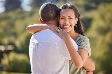 Image showing Couple, love bond and hug after an engagement with wedding ring jewellery in nature, environment and peace park. Portrait of smile, happy or safety security in marriage between man and woman in trust