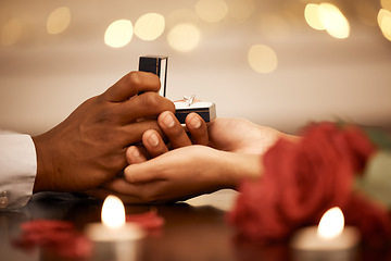 Image showing Ring, love and marriage proposal with couple on a romantic date and holding hands while asking the big engagement question. Commitment, anniversary and gift from a man to fiance woman to be engaged