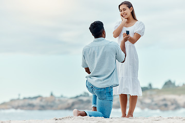 Image showing Beach proposal, engagement and surprise woman for love, care and relationship commitment together. Young, engaged and happy marry me couple, summer seaside date and special romance marriage outdoors