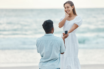 Image showing Love, beach and a proposal, a couple with engagement ring by the ocean. She said yes, woman and man at the sea with diamond ring. Wow, hope for future relationship and a summer marriage announcement.