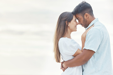 Image showing Date, love and couple at the beach hug, look in eyes and bonding together for anniversary, engagement or valentines day with mock up or copy space. Happy, intimate woman or people at outdoor vacation