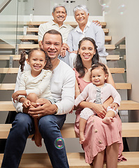 Image showing Portrait of a happy family posing for a picture on stairs in a house, smiling and relaxing together. Happy children bonding and enjoying time with their parents on a visit to their grandparents home