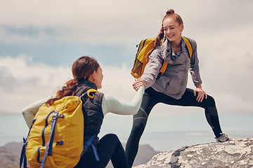 Image showing Help hands, friends or women hiking up a mountain, hill or in nature with a smile. Travel, adventure and trekking females on an outdoor, countryside or rock climbing recreation exercise activity.