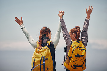 Image showing Women outdoor travel, celebrate success adventure and hiking support achievement on mountain top. Blue sky landscape, best friends love nature, sunshine at peak and calm freedom of girl sisters trip