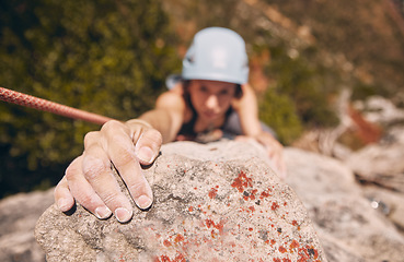 Image showing Woman, hand and rock climbing with rope on mountain, hill or remote hiking for workout, training and exercise. Fitness person in energy, risk and danger sports for wellness health in nature