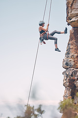 Image showing Woman climbing mountain with rope, outdoor nature activity and fitness exercise. Cliff rock climb, mountaineering adventure and action danger risk. Safety gear, peaceful earth and freedom motivation