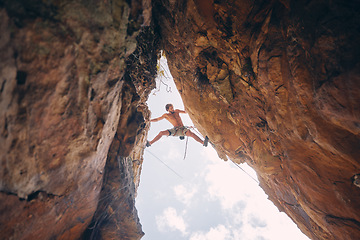 Image showing Mountain or rock climbing, cliff hanging and adrenaline junkie with courage on adventure trying to balance between gap. Athletic climber man doing fitness, exercise and workout during extreme sport