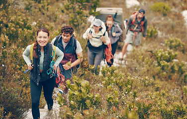 Image showing Group of friends hike trail up mountain, to camp in nature landscape on extreme adventure holiday. Team of people explore earth together, on hiking trip to mountains or hill while on vacation.