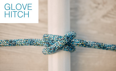 Image showing Above of hiking rope tied in a knot against a wooden background in studio. Glove hitch knot in a strong rope to secure safety while mountain climbing or extreme sports adventure.