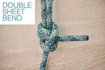 Image showing Rope climbing for mountain rock hiking, strong secure safety knot tie and closeup zoom on wood background. Double sheet bend in marine military training, army equipment to link and connect thread