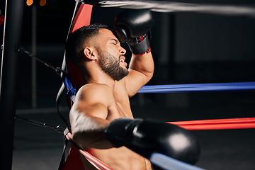 Image showing Tired boxer, fitness and sports competition in boxing ring, relax during mma fight and breathing after wellness exercise training at gym. Frustrated Muay Thai athlete without energy for workout