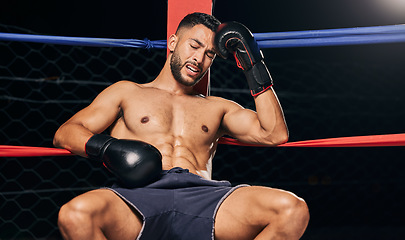 Image showing Sports, boxing ring and tired frustrated boxer with head pain, injury or fatigue from exhibition competition. Defeat or failure in fight challenge, workout or training burnout from fitness exercise