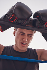 Image showing Fitness, tired and injured boxing man in workout, training or exercise at wellness gym. Face, stress or in pain boxer with burnout in kickboxing or fighting ring in game, match or sports competition