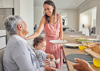 Image showing Mom, baby and grandmother eating at table, bonding and sharing food and love at home. Happy, smile and relax women bonding while having a meal, enjoying family time and being loving and caring