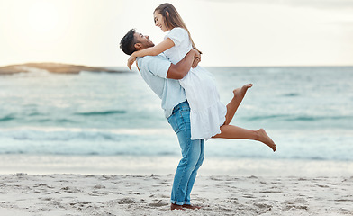 Image showing Man hug and lift woman on beach celebrate love with smile near water on summer holiday, vacation or luxury sea travel. Happy couple or people, celebration together on tropical ocean sand in Bali