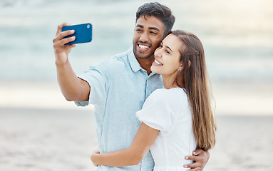 Image showing Couple, beach selfie and smile for happy travel fun, freedom day and relaxing summer vacation outdoors. Photos and young people celebrate with love hug on holiday, romance together and honeymoon date