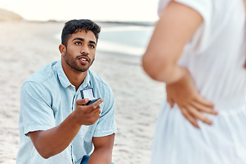 Image showing Engagement ring, man and beach proposal for surprise, love and relationship commitment to girlfriend. Young, engaged and marry me couple, summer seaside date and special romance marriage outdoors