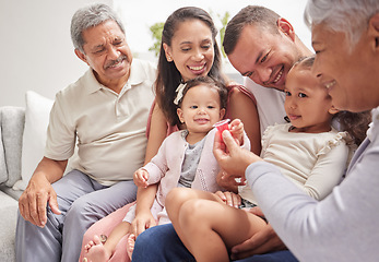 Image showing Family, love and children with grandparents and kids on a sofa in the living room during a visit at home. Happy, smile and relationship with a man, woman and relatives sitting in a house together