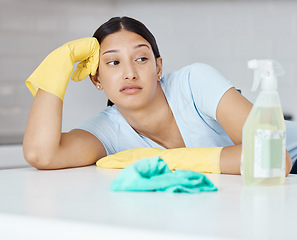 Image showing Cleaning, covid and hygiene with a bored woman cleaner looking at a spray bottle or sanitizer with a negative expression. Chores, clean and sanitizing with a young female unhappy about housework