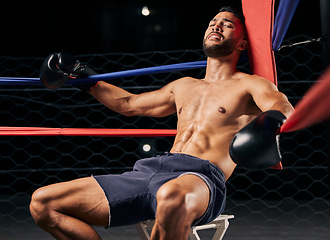Image showing Fitness, boxer and man tired in ring out corner exhausted from sports boxing match at the gym or arena. Active male in fight club, fatigue and relaxing from intense fighting sport workout or exercise