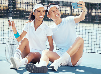 Image showing Selfie, sports or couple sitting on a tennis court resting after exercise, practice or training. Wellness, fitness or health with an interracial man and woman with sport racket taking a phone picture