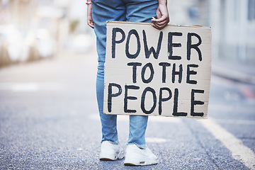 Image showing Power to the people cardboard protest poster in a city street for politics, government or human rights. Voice opinion board for freedom, equality or sign for society, racism and poverty background