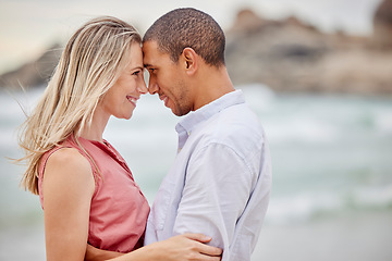 Image showing Interracial couple, beach and love bond with forehead together in trust, security or safety. Smile, happy or latino man and woman in hug by ocean or sea water in nature environment for honeymoon date