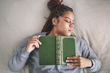 Image showing Tired, sleeping student with book on bed after studying, reading or learning knowledge at home. Burnout gen z or young black woman asleep in bedroom with textbook for university scholarship education