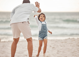 Image showing High five, beach and father and daughter bonding near ocean water, having fun and playing in nature. Parent and child good time, enjoying freedom and their bond, happy vacation celebration in Mexico