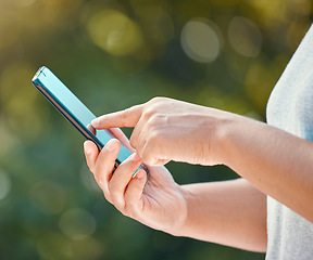 Image showing Hands, phone and woman in park searching social media, internet and news blog in nature, garden background or backyard. Zoom on relax person with 5g communication, mobile technology and online game