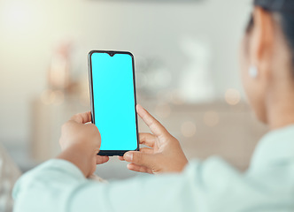Image showing Mockup, marketing and advertising on a phone with a blue screen in the hands of a woman in her home. Product placement, logo and brand on a mobile display for a creative website or homepage design