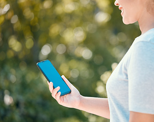 Image showing Nature walk for woman with mockup phone for peace of mind, healthy mindset or freedom with blue screen chroma key. Girl with smartphone copy space walking in outdoor park for wellness or exercise