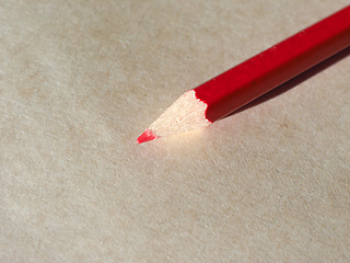 Image showing Red pencil over paper