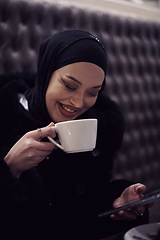 Image showing happy Middle Eastern female having break take a cup of tea in restaurant