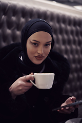 Image showing happy Middle Eastern female having break take a cup of tea in restaurant