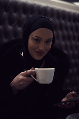 Image showing happy Middle Eastern female having break take a cup of tea in restaurant