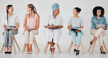 Image showing Diversity, interview and business people in waiting room at a job, hiring or recruitment center. Corporate, women and professionals talking with technology in a unemployment office for a work vacancy