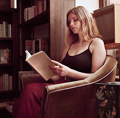 Image showing Library, books and woman reading a book in a bookstore or home study, relax and peaceful. Rest, carefree and hobby by young girl enjoying literature and an interesting story or novel while sitting