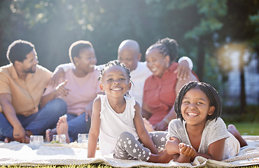 Image showing Happy children, picnic and black family relax, bond and enjoy free time together in nature. Portrait of little African sisters smile in happiness for summer outdoors with parents and grandparents