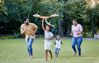 Image showing Black family, kite and outdoor fun with parents and children having fun and playing outside at a park in nature. Energy, love and running while being active and bonding with man, woman and kids