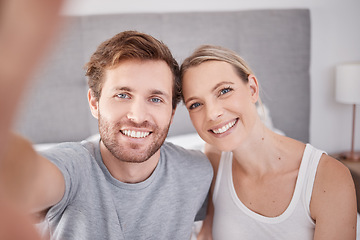Image showing A selfie in bedroom of man and woman as couple. Portrait of young, happy and smiling people taking a picture together in the morning and wearing pajamas. Taking a photo with smile, bonding and love