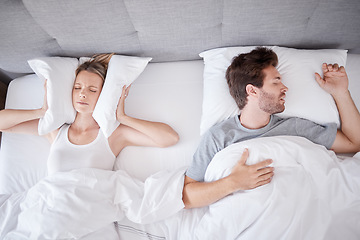 Image showing Sleeping, snoring and wife with pillow on ears to stop noise from husband in bed with sleep problem. Insomnia, frustration and stress with tired woman in bedroom lying next to man with apnea