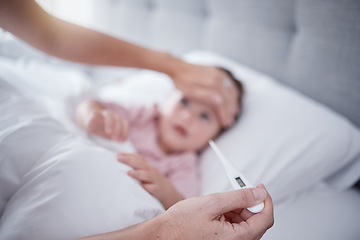 Image showing Hands, fever and baby with the hand of a mother taking the temperature with a thermometer of a sick daughter in bed at home. Female parent measuring or testing the symptoms of her girl in the bedroom