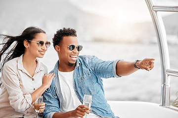 Image showing Couple love to travel on a luxury yacht at sea together on a romantic date in nature on a holiday vacation. Smile, happy and young boyfriend and woman enjoy champagne in the ocean on a boat cruise